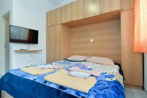 a bedroom with a bed with towels on it at Apartments Marijan 105 in Pula
