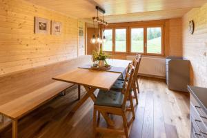 a dining room with a wooden table and chairs at Rosenhaus 3 in Schwarzenberg