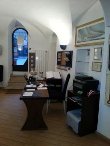 a living room with a table and chairs and a window at Hotel Argentina in Santa Margherita Ligure