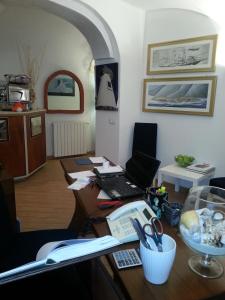 an office with a desk with a computer and scissors at Hotel Argentina in Santa Margherita Ligure