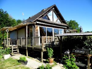 a small house with a porch and large windows at Le petit Marais n° 2 in Nouan-le-Fuzelier