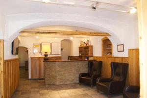 a bar in a room with two chairs at Hotel Raibl e Appartamenti in Tarvisio