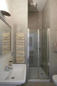 a bathroom with a glass shower and a sink at La Canarina Bed & Breakfast in Como