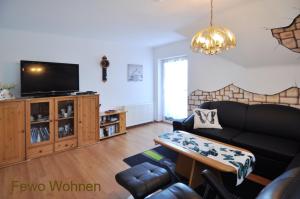 TV a/nebo společenská místnost v ubytování Accanto Appartement Ferienwohnung