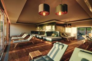 a living room with couches and chairs and a fireplace at Landgut am Pößnitzberg in Leutschach