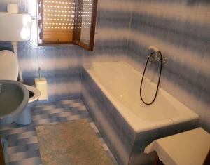 a bathroom with a tub and a toilet and a sink at Apartment Kampor 10 in Kampor