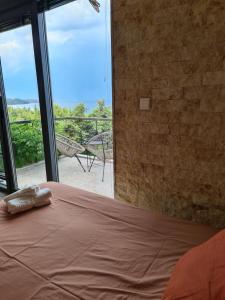 a bedroom with a bed and a large glass window at Janis Seaview Villa in Nea Fokea +41 photos