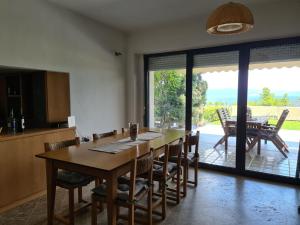 a kitchen and dining room with a table and chairs at Janis Seaview Villa in Nea Fokea