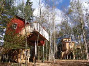 a tree house in the woods with two levels at Baumhaus Hotel Voglsam in Schönau