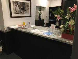 a counter in a room with flowers on it at Commercial Motel in Hay