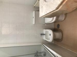 a bathroom with a sink and a bath tub at Albergue O Cruceiro in Caldas de Reis