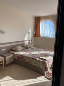 a small bedroom with a bed and a window at Andalusia 2 Apartments in Elenite