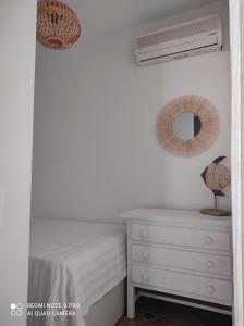 a bedroom with a bed and a dresser and a mirror at pita azul in Las Negras