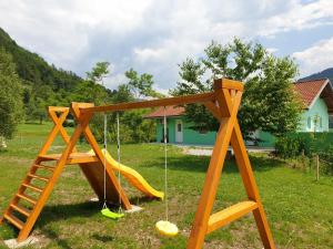 a playground with a slide and a ladder at Apartma Patricija - cozy apartments in Tolmin