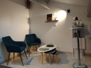 two blue chairs and a table in a room at Lou calado in Fayence