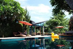 a house with a swimming pool with a house at Family House Zen Boutique Resort in Pai