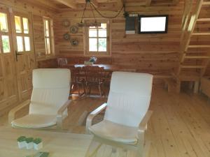 a room with two chairs and a table in a cabin at Drinska Tisina in Ljubovija