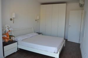 um quarto com uma cama branca e uma mesa de cabeceira em Residence Empire em Cattolica