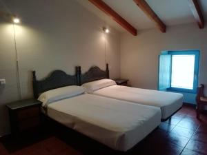 Een bed of bedden in een kamer bij Casa Pedroso
