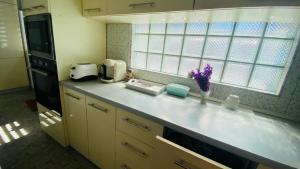 eine Küche mit einer Arbeitsplatte mit Blumen darauf in der Unterkunft SunRise Apartament in Mangalia