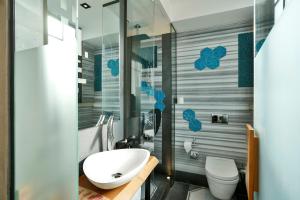 a bathroom with a sink, toilet and bathtub at Hotel The Public - Special Category in Istanbul