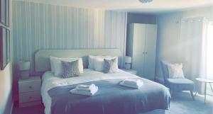 1 dormitorio con 1 cama con toallas en The Hand Hotel en Chirk