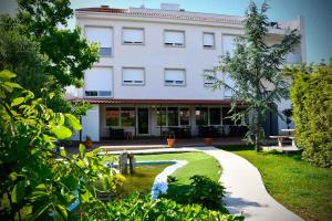 un edificio con una fontana in mezzo a un cortile di Pincheiro Apartamentos Turísticos a A Pobra do Caramiñal