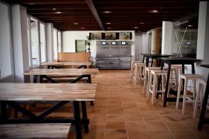 un restaurante con mesas de madera y sillas en una habitación en Pincheiro Apartamentos Turísticos en Pobra do Caramiñal