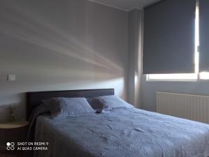 Łóżko lub łóżka w pokoju w obiekcie Ecorooms PADRÓN