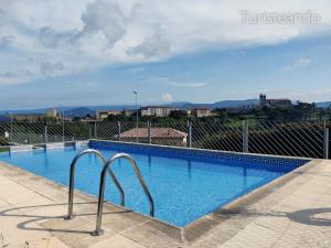 a swimming pool with a view of a city at Dúplex Marisma de Pombo - Parking privado y vistas inolvidables in San Vicente de la Barquera
