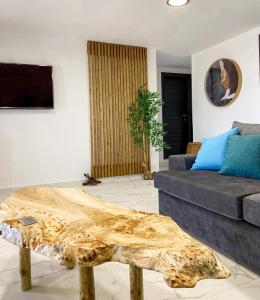 a living room with a couch and a wooden coffee table at Seafront Oasis Beach Houses in Ierissos