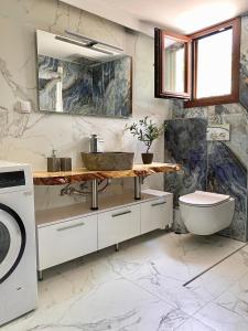 a bathroom with a sink and a washing machine at Seafront Oasis Beach Houses in Ierissos +43 photos