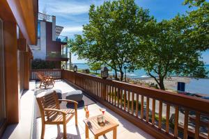 a balcony with chairs and a table and a view of the ocean at Mala Garden Design Hotel in Siófok
