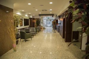 a hallway with chairs and tables in a building at Dila Hotel in Istanbul