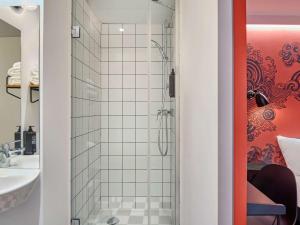 a bathroom with a shower and a sink at Ibis Styles Paris Gare de l'Est Magenta in Paris