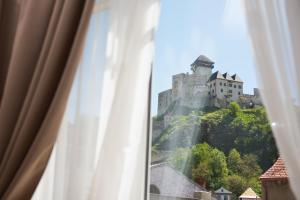 a view of a castle from a window at Penzión Branecky in Trenčín