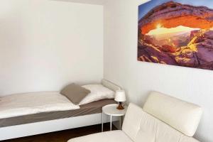 a small bedroom with a bed and a chair at 1 Zimmer Apartment mit Balkon in Glauchau