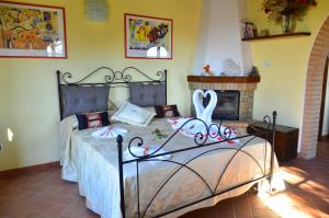 a bedroom with a bed with a ribbon on it at Agriturismo L'impero in Santa Luce