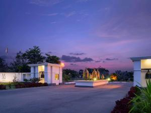 a building with a fountain in the middle of a driveway at The Lake Garden Nay Pyi Taw - MGallery Collection in Nay Pyi Taw