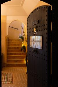 a door with a sign on it in front of a staircase at RIAD KERDOUSS in Marrakech