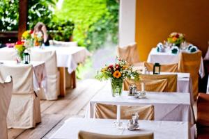 a table set up for a wedding with white tables and flowers at Hotel Gasthof Lercher in Murau