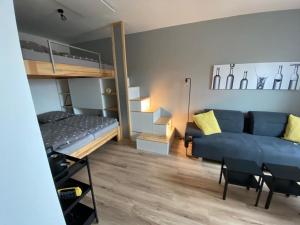 a living room with a blue couch and a bunk bed at Apartmán Domenica 404 in Mikulov
