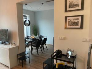 a dining room and living room with a table and chairs at Apartmán Domenica 404 in Mikulov