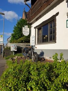a motorcycle parked in front of a building at Hotel Restaurant Bauernstube in Eschenburg