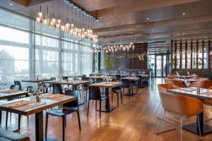 a restaurant with tables and chairs and windows at Radisson Blu Hotel Istanbul Asia in Istanbul
