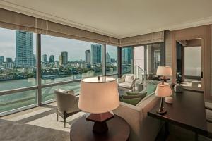 a living room with a view of a city at Capella Bangkok in Bangkok