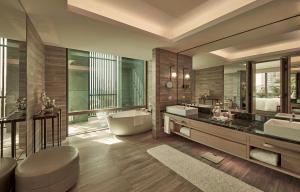 a large bathroom with two sinks and a tub at Capella Bangkok in Bangkok