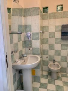 a bathroom with a sink and a toilet at Affittacamere La Petra Longa in San Teodoro +37 photos