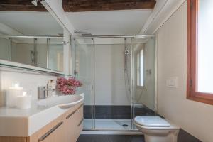 a bathroom with a glass shower and a toilet at Corte Contarina San Marco Apartment R&R in Venice