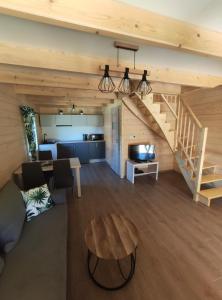 a living room with a staircase and a couch and a table at Słoneczny Domek in Kluszkowce +21 photos
